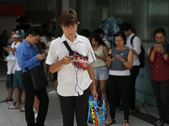 Thai 'Pokemon Go' players gather to play the game on their smartphones at a shopping mall in Bangkok, Thailand, 08 August 2016. The 'Pokemon Go' game allows smartphone users to use GPS to catch Pokemon characters in their surroundings. The National Broadcasting and Telecommunications Commission (NBTC) is expected to issue 'No Pokemon catching' zone restrictions for places especially at religious and historic sites such as the Royal Palace, Buddhist temples, import