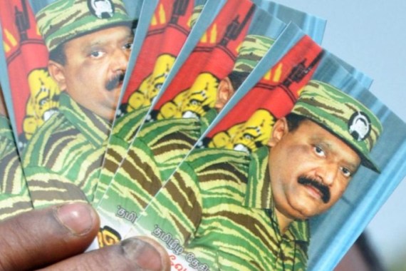 A Tamil activist displays portraits of Tamil tiger leader Velupillai Prabhakaran, who was killed in Sri Lanka s civil war in 2009, during a protest against the visit of Sri Lankan President Mahinda Rajapaksa to India, in Tirupati, India, Friday, Feb. 8, 2013. Tamils in various parts of the country are protesting Rajapaksa s two-day personal visit to religious places of worship in India.