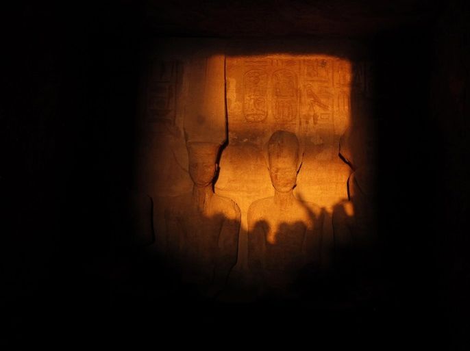 The light of dawn shines on the statues of Pharaoh Ramses II (R) and Amun, the God of Light (L), in the inner sanctum of the temple of Abu Simbel, located at the upper reaches of the Nile in Aswan, around 1264 km (785 miles) south of Cairo February 22, 2014. The axis of the temple was designed so as to allow the rays of the sun to shine into the inner sanctuary only on Ramses II's birthday and his coronation. A militant Islamist group has warned tourists to leaveEgypt and threatened to attack any who stay after Feb. 20, raising the prospect of a new front in a fast-growing insurgency in the biggest Arab nation. . REUTERS/Mohamed Abd El Ghany (EGYPT - Tags: TRAVEL CIVIL UNREST)
