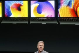 Phil Schiller, senior vice president of worldwide marketing at Apple, speaks under a graphic of the new MacBook Pro laptop computers during an Apple media event in Cupertino, California, U.S. October 27, 2016. REUTERS/Beck Diefenbach