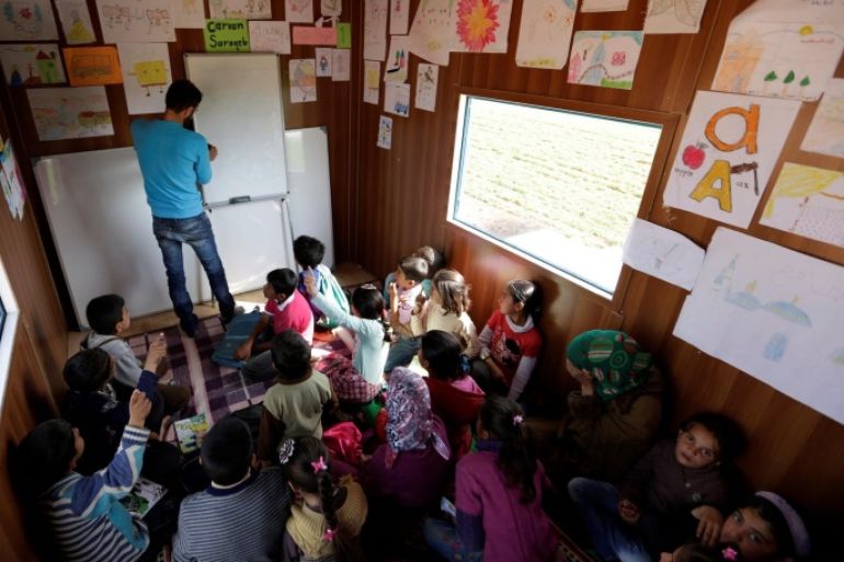 A volunteer teacher teaches inside a mobile educational caravan for children who do not have access to schools on the outskirts of the Syrian rebel-held town of Saraqib, Idlib province March 10, 2016. The group "Saraqib Youth Gathering" created a mobile learning caravan to reach children who have no access to schools in the area. REUTERS/Khalil Ashawi SEARCH "SYRIA SCHOOLS" FOR THIS STORY. SEARCH "THE WIDER IMAGE" FOR ALL STORIES