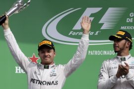 Formula One - F1 - Mexican F1 Grand Prix - Mexico City, Mexico - 30/10/16 - Second placed finisher Mercedes driver Nico Rosberg of Germany (L) celebrates as his teammate, race winner Lewis Hamilton of Britain, applauds. REUTERS/Henry Romero