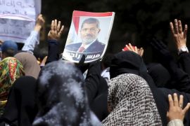 Supporters of the Muslim Brotherhood and deposed Egyptian President Mohamed Mursi shout slogans while gesturing the Rabaa sign, symbolizing support for the Muslim Brotherhood, during a rally against an Egyptian court's decision to sentence Mursi and other leaders to death, in Al Haram street near Giza square, south of Cairo, Egypt June 19, 2015. Mursi will appeal against a conviction for violence, kidnapping and torture imposed by a court over the killing of protesters