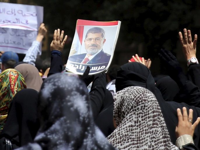 Supporters of the Muslim Brotherhood and deposed Egyptian President Mohamed Mursi shout slogans while gesturing the Rabaa sign, symbolizing support for the Muslim Brotherhood, during a rally against an Egyptian court's decision to sentence Mursi and other leaders to death, in Al Haram street near Giza square, south of Cairo, Egypt June 19, 2015. Mursi will appeal against a conviction for violence, kidnapping and torture imposed by a court over the killing of protesters
