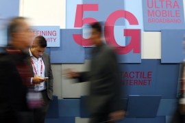 People walk past a 5G banner during the Mobile World Congress in Barcelona, Spain February 23, 2016. REUTERS/Albert Gea