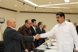 Venezuela's President Nicolas Maduro (R) shakes hands with Jesus Torrealba (L), secretary of Venezuela's coalition of opposition parties (MUD), during a political meeting between government and opposition, in Caracas, Venezuela October 30, 2016. Miraflores Palace/Handout via REUTERS ATTENTION EDITORS - THIS PICTURE WAS PROVIDED BY A THIRD PARTY. EDITORIAL USE ONLY. TPX IMAGES OF THE DAY