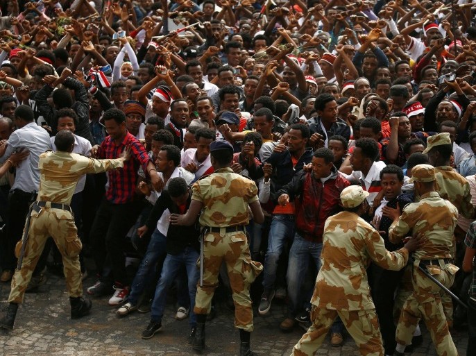 Demonstrators chant slogans while flashing the Oromo protest gesture during Irreecha, the thanksgiving festival of the Oromo people, in Bishoftu town, Oromiya region, Ethiopia, in this file photo taken October 2, 2016. REUTERS/Tiksa Negeri/File Photo