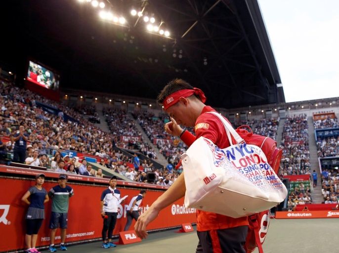 Tennis - Japan Open Men's Singles First Round match - Ariake Coliseum, Tokyo, Japan - 05/10/16. Kei Nishikori of Japan leaves the court after he retires during his match against Joao Sousa of Portugal. REUTERS/Kim Kyung-Hoon