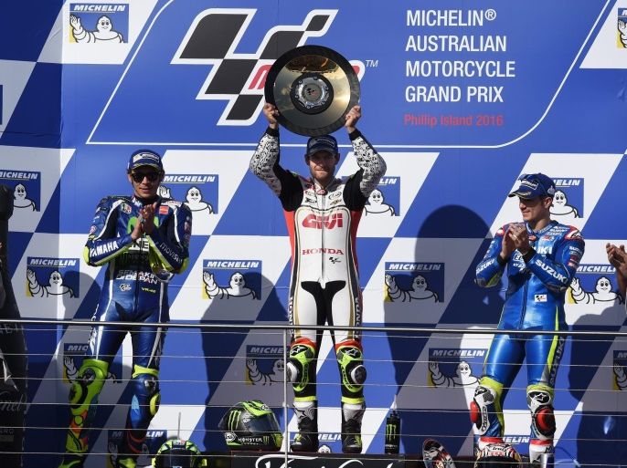 Britain's Cal Crutchlow of LCR Honda (C) as he celebrates his win along with second place Valentino Rossi (L) of Italy for Movistar Yamaha MotoGP and third place Maverick Vinales (R) of Spain for the Suzuki Ecstar after the 2016 Australian MotoGP, Philip Island, Victoria, Australia, 23 October 2016. EPA/TRACEY NEARMY AUSTRALIA AND NEW ZEALAND OUT