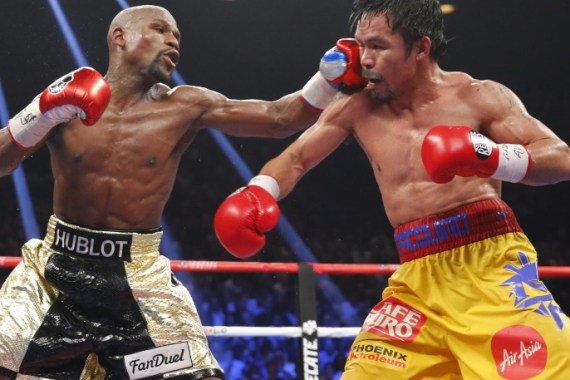 Floyd Mayweather, Jr. (L) of the U.S. lands a left to the face of Manny Pacquiao of the Philippines in the 11th round during their welterweight WBO, WBC and WBA title fight in Las Vegas, Nevada, in this May 2, 2015 file photo. Boxers Mayweather and Pacquiao topped Forbes 2015 list of the world's highest-paid celebrities June 29, 2015, thanks to their record-breaking lucrative Las Vegas fight that assured them earnings that surpassed those of musicians and actors. REUTERS/Steve Marcus/Files