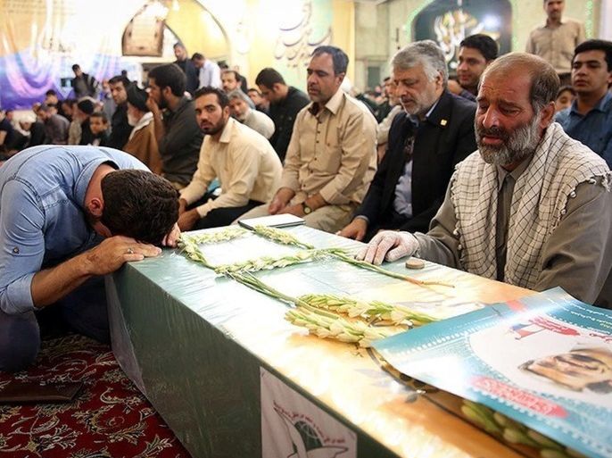 Mourners gather around the bodies of Iranians killed in Syria, during their funeral in Mashad, Iran in this handout photo obtained by Reuters September 21, 2016. Tasnim News Ageny/Handout via REUTERS ATTENTION EDITORS - THIS PICTURE WAS PROVIDED BY A THIRD PARTY. FOR EDITORIAL USE ONLY. NO RESALES. NO ARCHIVE.