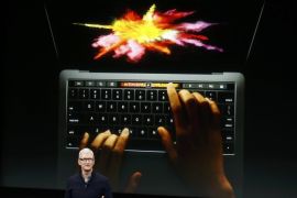 Apple CEO Tim Cook speaks under a graphic of the new MacBook Pro during an Apple media event in Cupertino, California, U.S. October 27, 2016. REUTERS/Beck Diefenbach TPX IMAGES OF THE DAY