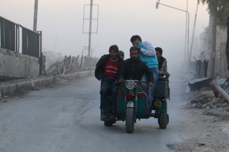 Men ride on a vehicle amidst dust after a strike on the rebel held besieged al-Shaar neighbourhood of Aleppo, Syria, November 26, 2016. REUTERS/Abdalrhman Ismail