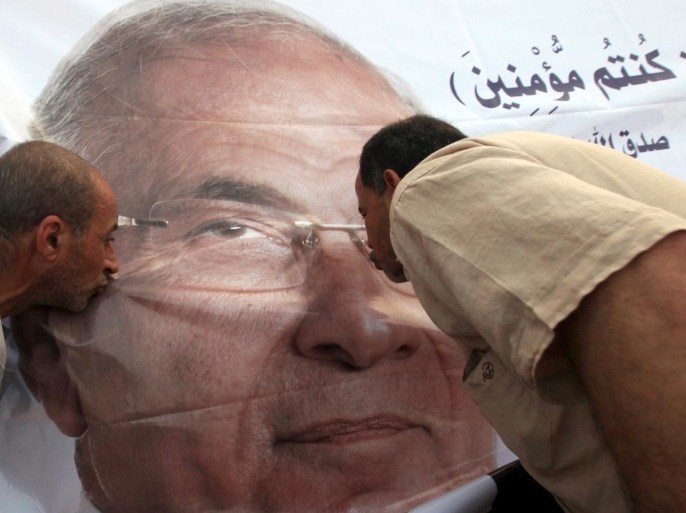 File photo shows supporters of former presidential candidate Ahmed Shafik kissing his poster during a protest at Nasr City in Cairo, Egypt, June 23, 2012. REUTERS/Amr Abdallah Dalsh/File Photo
