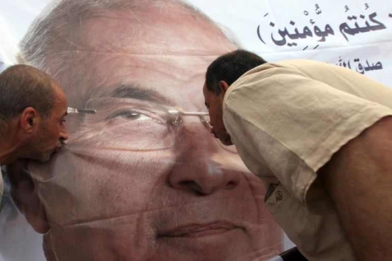File photo shows supporters of former presidential candidate Ahmed Shafik kissing his poster during a protest at Nasr City in Cairo, Egypt, June 23, 2012. REUTERS/Amr Abdallah Dalsh/File Photo