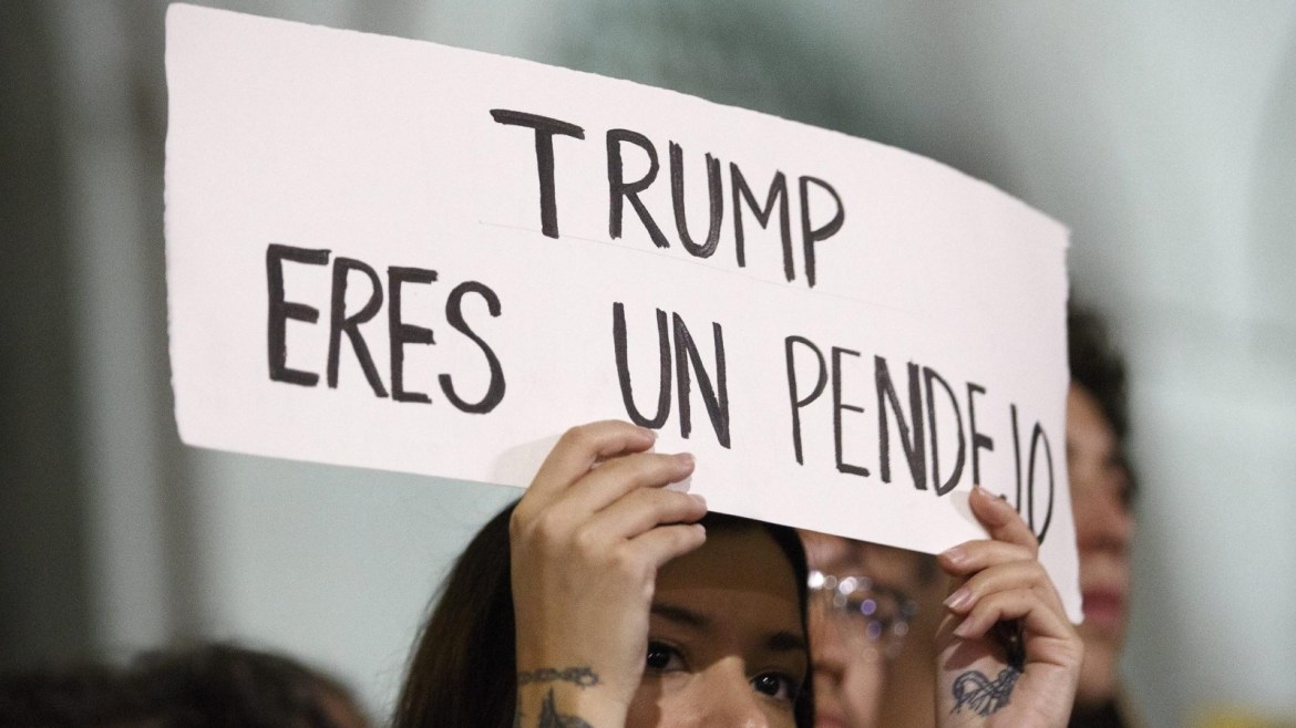 A woman holds up a sign reading 'Trump you are an Idiot' as demonstrators gather during a protest against President-elect Donald Trump outside the City Hall building in Los Angeles, California, USA, 09 November 2016. Thousands filled the streets of downtown area of Los Angeles to march against the Trump presidency.