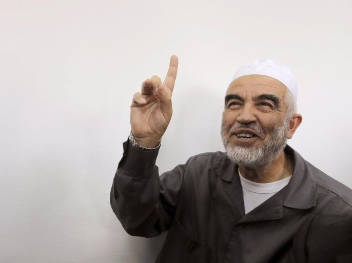 Leader of the northern Islamic Movement Sheikh Raed Salah gestures as he sits inside the district court in Jerusalem October 27, 2015. The Arab Israeli Muslim leader, seen by Israel as a powerful voice stoking Palestinian anger over a Jerusalem holy site, was ordered jailed for 11 months on Tuesday for comments he made in 2007. Sheik Raed Salah, leader of the Islamic Movement's northern section was convicted for incitement to violence in 2013, the Justice Ministry said