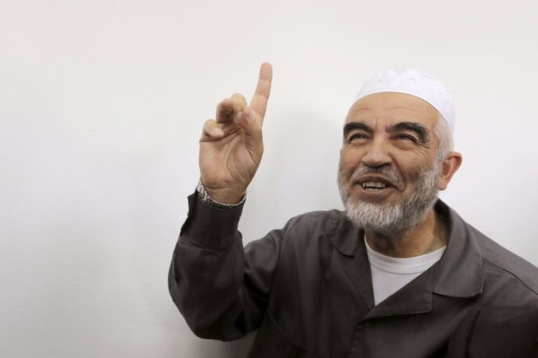 Leader of the northern Islamic Movement Sheikh Raed Salah gestures as he sits inside the district court in Jerusalem October 27, 2015. The Arab Israeli Muslim leader, seen by Israel as a powerful voice stoking Palestinian anger over a Jerusalem holy site, was ordered jailed for 11 months on Tuesday for comments he made in 2007. Sheik Raed Salah, leader of the Islamic Movement's northern section was convicted for incitement to violence in 2013, the Justice Ministry said