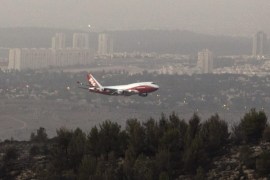 The USA fire fighting super tanker known as 'Global Supertanker' and bearing the tail number 944 flies low before going behind a hill outside Neve Ilan, Israel, west of Jerusalem on 26 November 2016 as it assists in fire fighting in Israel following days of fires from Haifa in the north to the outskirts of Jerusalem. The plane circled once and then flew low behind the hill, but it is not known if the plane dropped its load of water or flame retardant when behind the