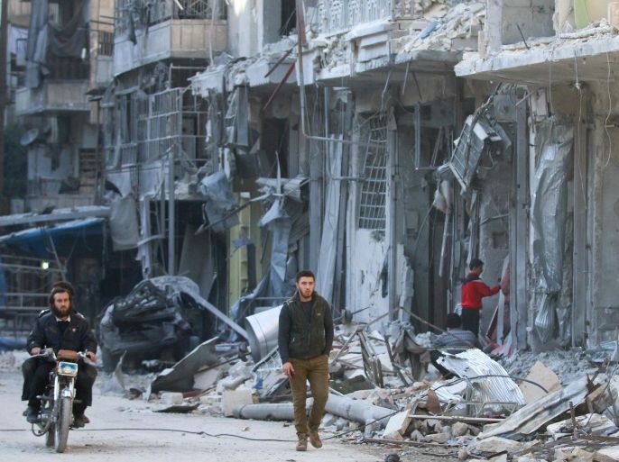 Men are pictured next to damaged buildings at a site hit yesterday by airstrikes in the rebel held al-Shaar neighbourhood of Aleppo, Syria November 17, 2016. REUTERS/Abdalrhman Ismail