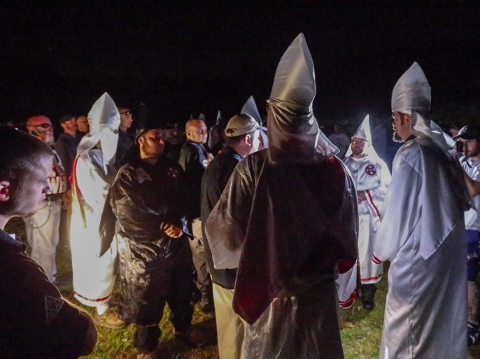 A picture made available on 24 April 2016 shows Pro-white rights organizations the neo-nazi National Socialist Movement and Ku Klux Klan groups participate in a cross and swastika burning in Temple, Georgia, USA, 23 April 2016. The ceremony was held after a day of rallies at Stone Mountain and Rome, Georgia, and to show successful collaboration agreements between the NSM and KKK, two white extremist groups.