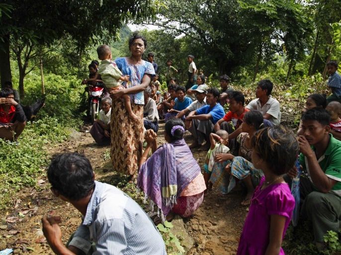 Villagers of Aung Thayar gather in jungle as they flee and hide from fights near Maungdaw town of Bangladesh-Myanmar border, Rakhine State, western Myanmar, 13 October 2016. Fightings continue at Maungdaw as dozens of native Rakhine ethnics minority flee from the area which remain at least four militants and nine policemen dead since after three border police posts were attacked at the same time by unknown attackers shouting the word 'Rohingya' loud and saying regional Bengali language at the early morning of 09 October 2016 near Maungdaw, Muslim majority town at Bangladesh-Myanmar border.