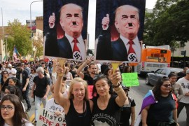 Demonstrators hold placards depicting US President-elect Donald Trump as Hitler as thousands march in reaction to the election of Donald Trump as the 45th president of the United States in Los Angeles, California, USA, 12 November 2016.