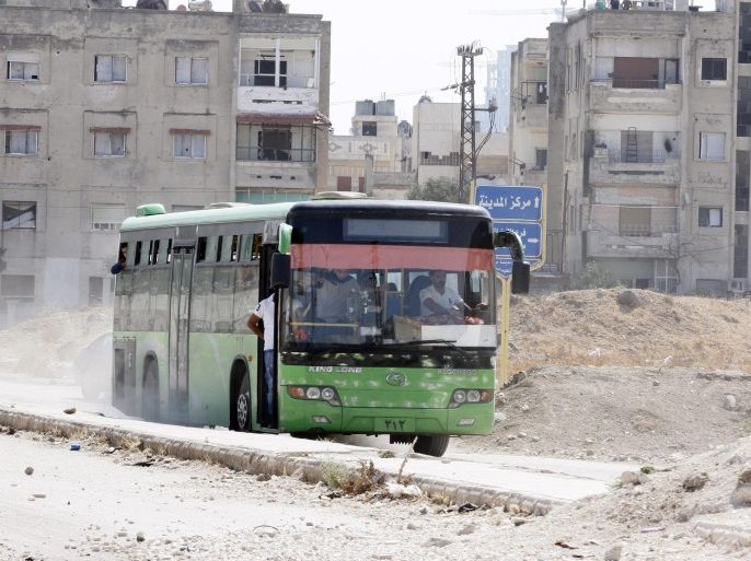 epaselect epa05551826 A bus, carrying rebels and family members, leave the besieged neighborhood of al-Waer in the central city of Homs, Syria, 22 September 2016. According to media reports, some 120 gunmen, some of them are accompanied by their families, got out of al-Waer, as part of the third phase of agreement of settlement with the Syrian government. The evacuees are expected to head to the northern countryside of Homs.