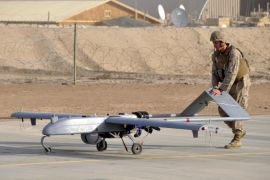 A U.S. Marine with Marine Unmanned Aerial Vehicle Squadron 1 pushes an RQ-7B Shadow UAV following its landing at Camp Leatherneck, Afghanistan in this November 10, 2011 USMC handout photo obtained by Reuters February 6, 2013. To match Exclusive AFGHANISTAN-DRONES/ U.S. Marine Corps/Sgt. Eric D. Warren/Handout via Reuters/File Photo ATTENTION EDITORS - THIS IMAGE HAS BEEN SUPPLIED BY A THIRD PARTY. FOR EDITORIAL USE ONLY.