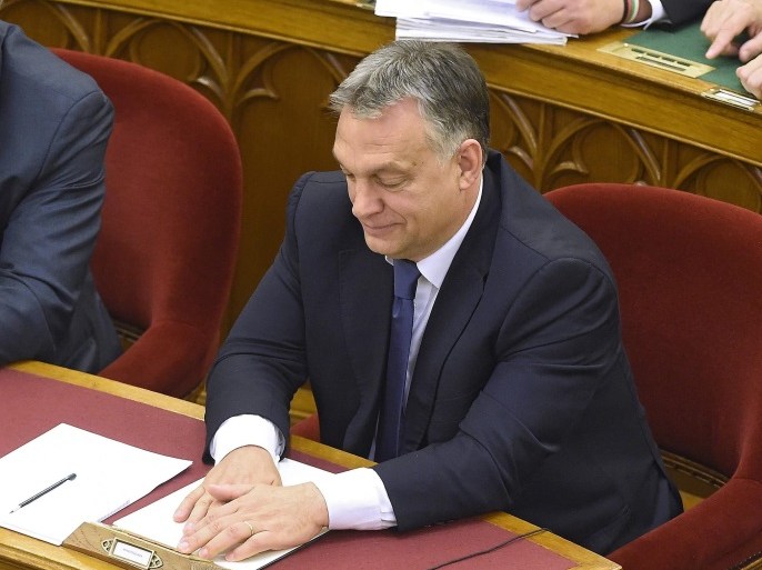 epaselect epa05622019 Hungarian Prime Minister Viktor Orban presses a knob during the vote on the amendment of the Constitution during the plenary session of the parliament in Budapest, Hungary, 08 November 2016. 131 representatives voted YES and three voted NO, thus the two-third majority was not achieved in order to change the Constitution. The goal of the planned amendment was Hungary's political objective to prevent the mandatory quotas, proposed by the European Co