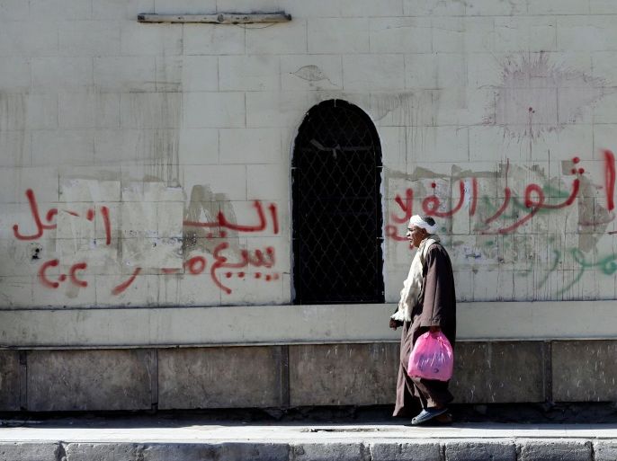 A man walks in front of a wall with graffiti in support of the Ghalaba Movement, asking Egyptians to participate in demonstrations against the Egyptian regime on November 11, in Cairo, Egypt November 9, 2016. The words read, "Ghalaba" (Marginalised)" (L) and "Sisi sells Egypt". REUTERS/Amr Abdallah Dalsh