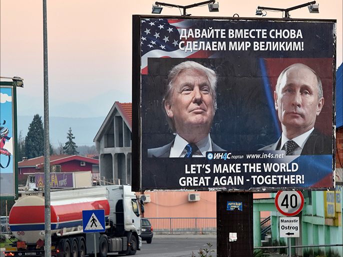 epa05634156 A billboard by pro-Serbian movement shows the image US President-elect Donald Trump and Russian President Vladimir Putin as a truck drives past in the town of Danilovgrad, Montenegro, 16 November 2016. Presidents Donald Trump and Vladimir Putin spoke by phone of better relations in the future between Washington and Moscow on 15 November. EPA/BORIS PEJOVIC