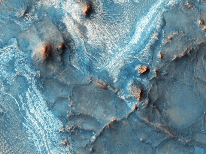 A handout photo made available by the National Aeronautics and Space Administration (NASA) on 04 May 2016 and taken on 05 February 2016, at 14:54 local Mars time by the High Resolution Imaging Science Experiment (HiRISE) camera on NASA's Mars Reconnaissance Orbiter shows the Nili Fossae region, located on the northwest rim of Isidis impact basin, one of the most colorful regions of Mars. The colors over many regions of Mars are homogenized by the dust and regolith, but