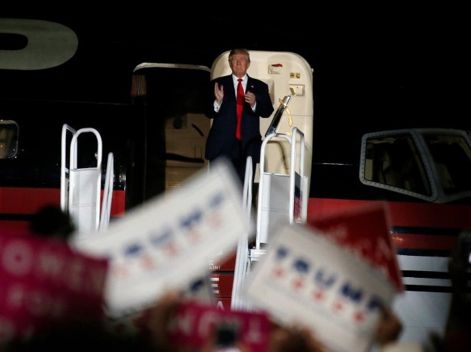 Republican presidential nominee Donald Trump waves from his plane as he departs an airport campaign rally in Albuquerque, New Mexico, U.S. October 30, 2016. REUTERS/Carlo Allegri