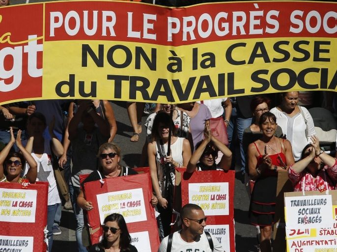 Women attend a demonstration in Marseille, Southern France, 15 September 2016. French unions have called a national day of protest against the working law reform. The banner reads 'For social progress. No to the breaking of social working'.
