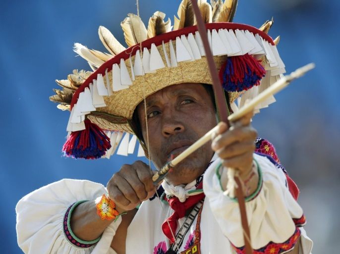 An indigenous man from Mexico fires an arrow during the bow-and-arrow competition at the first World Games for Indigenous Peoples in Palmas, Brazil, October 26, 2015. REUTERS/Ueslei Marcelino