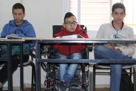 القدس - 7-علي محمد علي يجلس على كرسيه المتحرك بالصف بجانب طلبة أصحاء