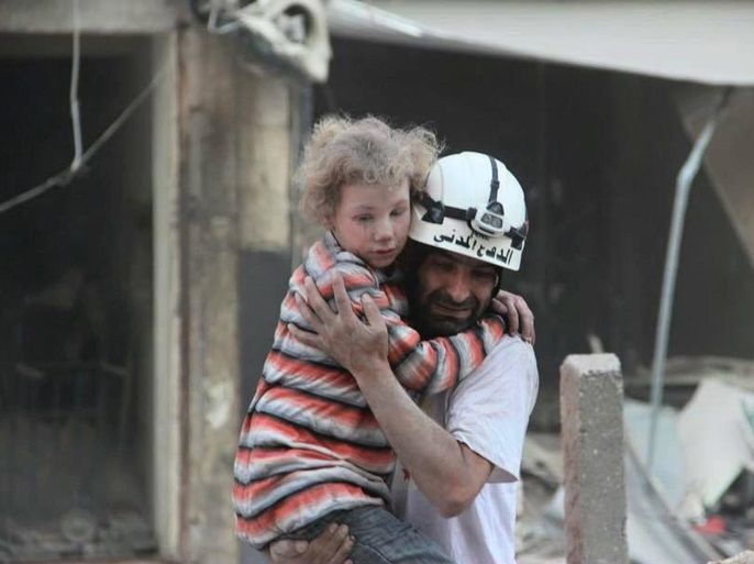 An undated handout picture made available by the Syria Civil Defence volunteer organization on 07 October 2016 showing a volunteer carrying a child victim in Aleppo, Syria. Syria Civil Defence is a volunteer group, also known as the White Helmets, that consists of over three thousand local volunteers spread across areas of conflict around Syria. In the past three years they saved over 62 thousand Syrian lives, while losing 145 volunteer during airstrikes and 430 others
