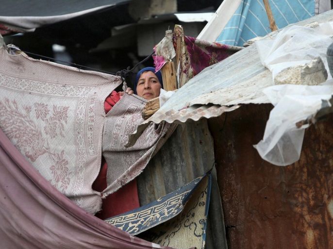 A Palestinian woman looks out of her family's shanty in Khan Younis, in the southern Gaza Strip November 30, 2016. REUTERS/Ibraheem Abu Mustafa