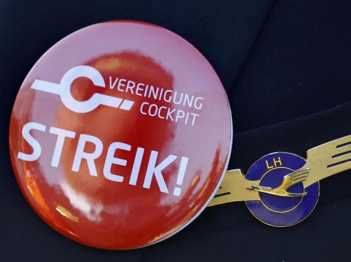 A pilot of German airline Lufthansa, sports a buttons reading "strike" on his uniform as he takes part in a demonstration at Fraport airport in Frankfurt, Germany April 2, 2014. REUTERS/Kai Pfaffenbach/File Photo