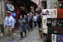 People pass by a picture of US President Barack Obama in Arab dress and President-elect Donald Trump in Jewish dress, displayed at a T-shirt store in the Old City of Jerusalem, Israel, 13 November 2016. Americans voted the republican party candidate Donald Trump on 08 November, to become the 45th President of the United States of America to serve from 2017 through 2020.