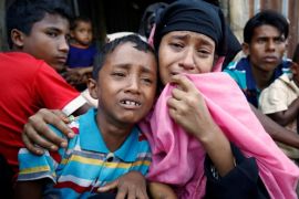 A Rohingya Muslim woman and her son cry after being caught by Border Guard Bangladesh (BGB) while illegally crossing at a border check point in Cox’s Bazar , Bangladesh, November 21, 2016. REUTERS/Mohammad Ponir Hossain TPX IMAGES OF THE DAY