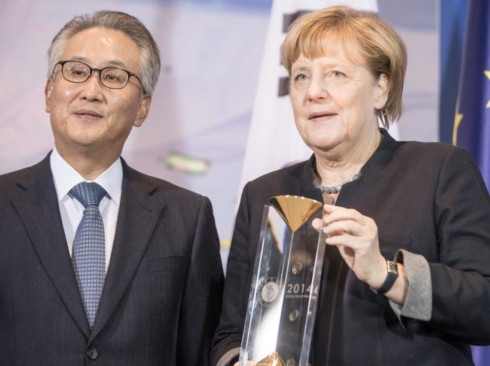 German Chancellor Angela Merkel (R) receives the Seoul Peace Prize from the General Secretary of the Seoul Peace Foundation Kim Seung-Chae (L) for her work in peace-making and against terrorism in Berlin, Germany, 02 November 2016. The Seoul Peace Prize was founded by the South Korean government in 1990. It is awarded every two years.
