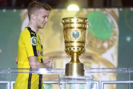 Dortmund's Marco Reus passes by the trophy after the German DFB Cup final soccer match between Bayern Munich and Borussia Dortmund at the Olympic Stadium in Berlin, Germany, 21 May 2016. (EMBARGO CONDITIONS - ATTENTION: The DFB prohibits the utilisation and publication of sequential pictures on the internet and other online media during the match (including half-time). ATTENTION: BLOCKING PERIOD! The DFB permits the further utilisation and publication of the pictures for mobile services (especially MMS) and for DVB-H and DMB only after the end of the match.)