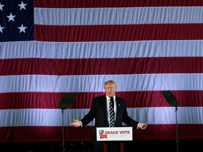 U.S. President-elect Donald Trump speaks beneath a giant American Flag during a "Thank You USA" tour rally in Baton Rouge, Louisiana, U.S., December 9, 2016. REUTERS/Mike Segar