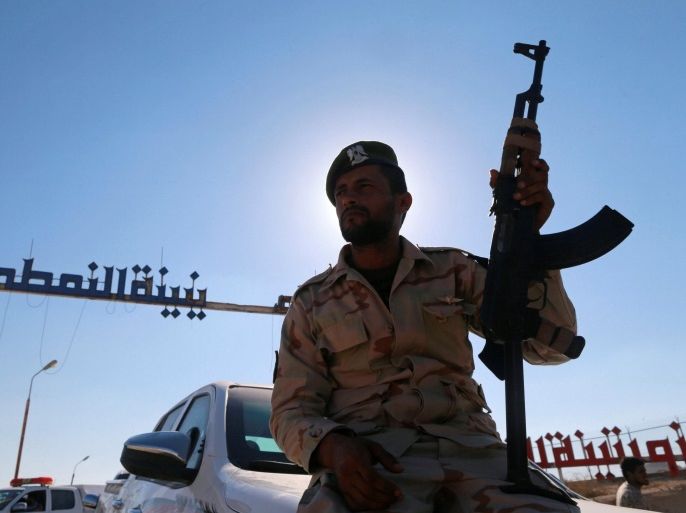 A member of Libyan forces loyal to eastern commander Khalifa Haftar holds a weapon as he sits on a car in front of the gate at Zueitina oil terminal in Zueitina, west of Benghazi, Libya September 14, 2016. Picture taken September 14, 2016. REUTERS/Esam Omran Al-Fetori