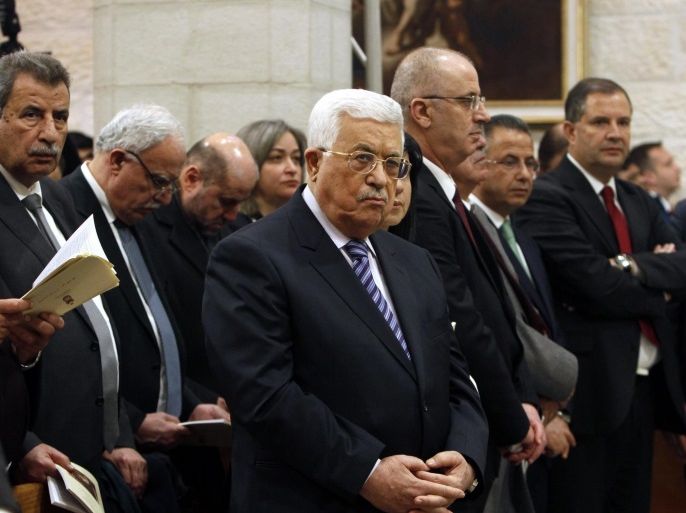 Palestinian President Mahmoud Abbas (C) attends the Christmas Midnight Mass in Saint Catherine's Church at the Church of the Nativity in Bethlehem, West Bank, 25 December 2016. Many Christians believe that the Virgin Mary gave birth to Jesus where the Church of Nativity now stands.