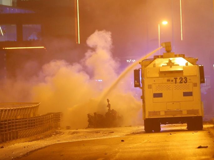 Police extinguish a burning car using a water cannon after a blast in Istanbul, Turkey, December 10, 2016. REUTERS/Murad Sezer