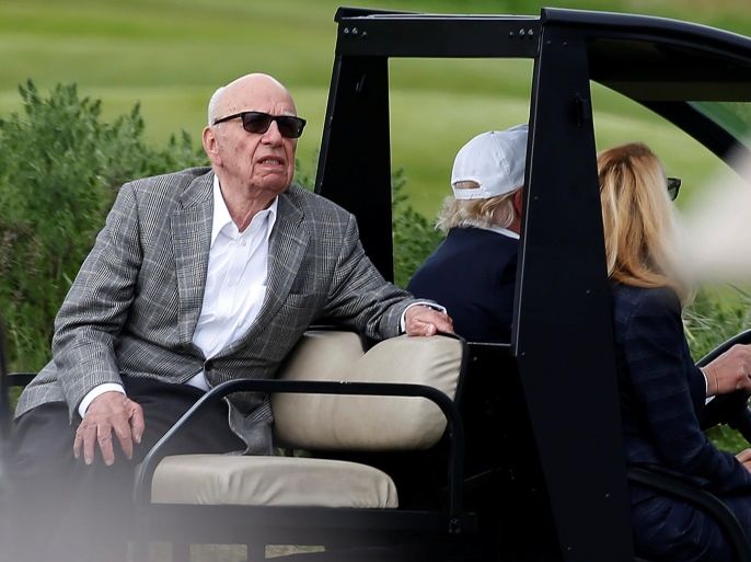Republican presidential candidate Donald Trump drives a golf cart with media mogul Rupert Murdoch (L) in the back and his wife, former model Jerry Hall in the passenger seat at Trump International Golf Links in Aberdeen, Scotland, June 25, 2016. REUTERS/Carlo Allegri