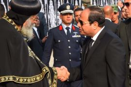 A handout picture made available by the Egyptian Presidency showing Egyptian President Abdel Fattah al-Sisi giving his condolonces to Pope Tawadros II of Alexandria, head of the Egyptian Coptic Orthodox Church, during the funeral service for the victims of the suicide bombing that killed 24 coptic christian, in front of the tomb of the unknown soldier, Cairo, Egypt, 12 December 2016. Egyptian President Abdel Fattah al-Sisi announced that 22-year-old suicide bomber named
